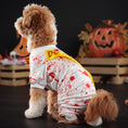 Charger l'image dans la visionneuse de la galerie, Side view of dog in white costume with red blood splatter pattern and yellow Do Not Enter sash, Halloween decor in background
