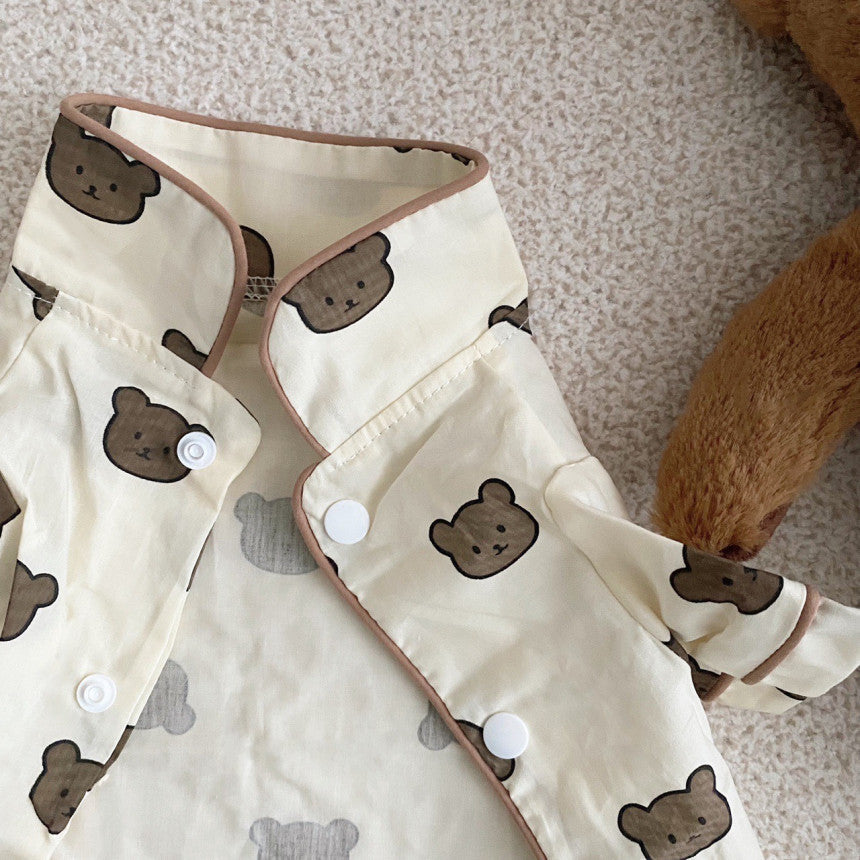 Close-up of shirt collar with snap buttons and detailed bear print on beige cotton fabric