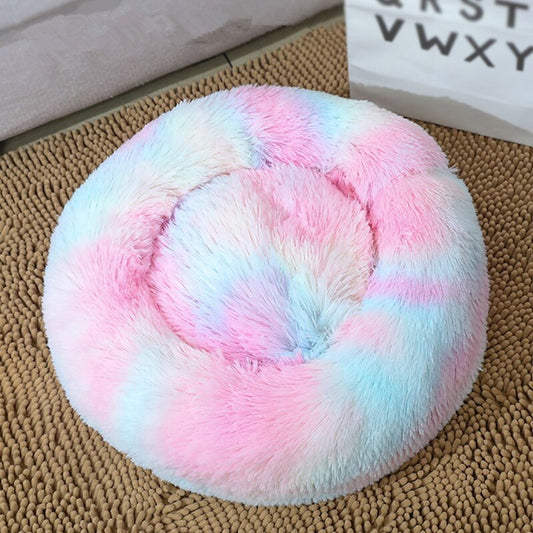 Top view of colorful pastel tie-dye round plush pet bed on rattan rug