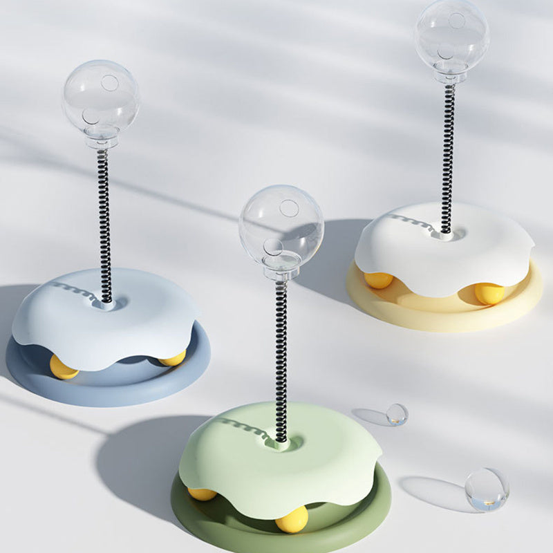 Three interactive cat treat toys in blue, green, and beige with clear treat containers and spring stems