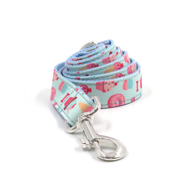 Close-up of adjustable dog leash featuring playful cupcake, candy, and donut patterns