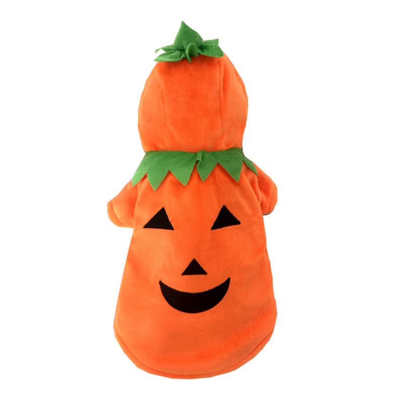 Flat lay front view of the bright orange pumpkin dog hoodie costume showing black jack-o-lantern face and green foliage design on hood