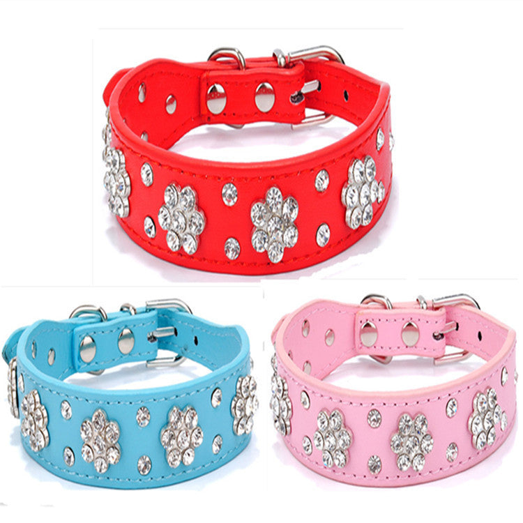 Close up of pink, blue, and red rhinestone dog collars showing floral design