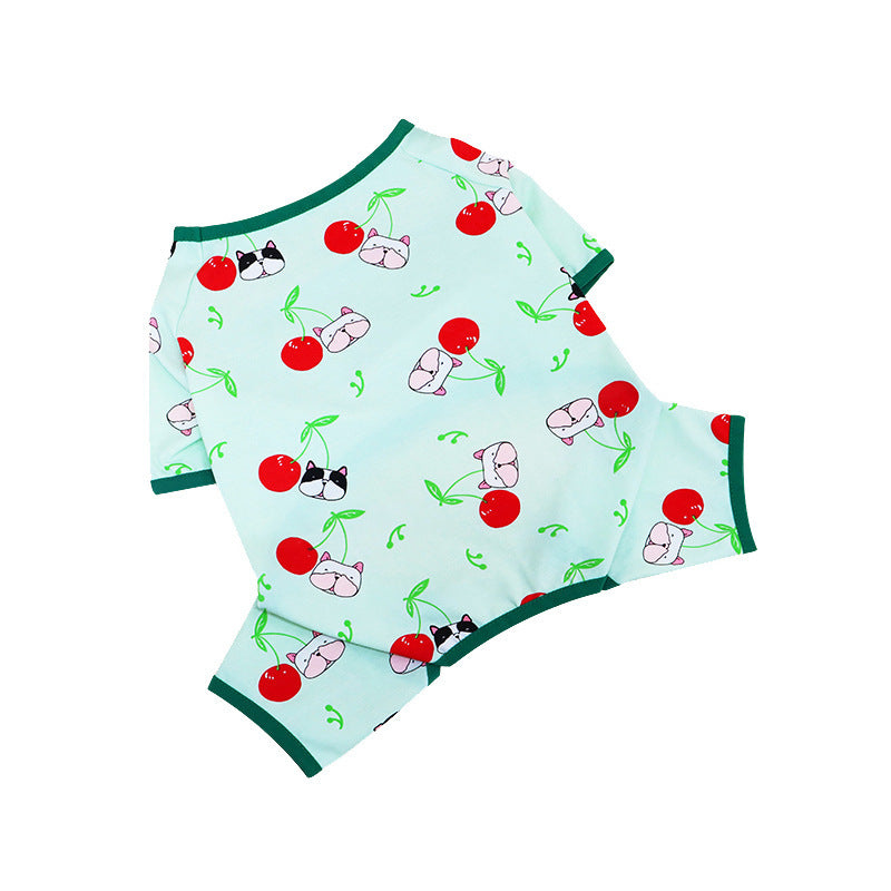 Flat lay of mint green dog pajamas decorated with cherry and dog faces pattern