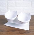 Load image into Gallery viewer, White pair of cat ear bowls on an elevated stand on a wooden surface
