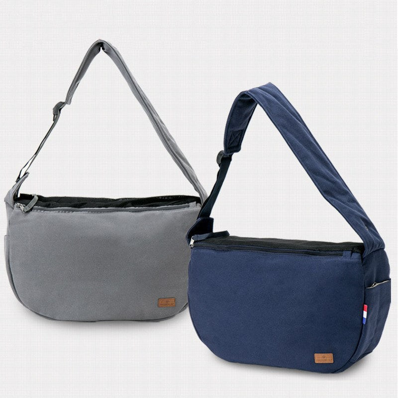 Close-up view of gray and navy blue pet travel shoulder bags with zippered tops and padded straps