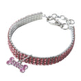 Charger l'image dans la visionneuse de la galerie, Pink rhinestone dog collar laid flat with crystal bone charm and metal clasp
