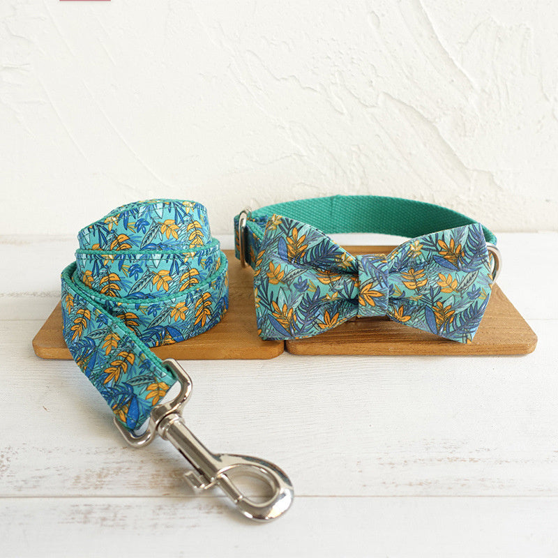Complete dog collar, leash, and bow tie set with teal floral print displayed on wooden surface