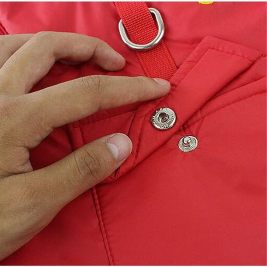 Close-up of red insulated dog coat snap button and leash attachment ring