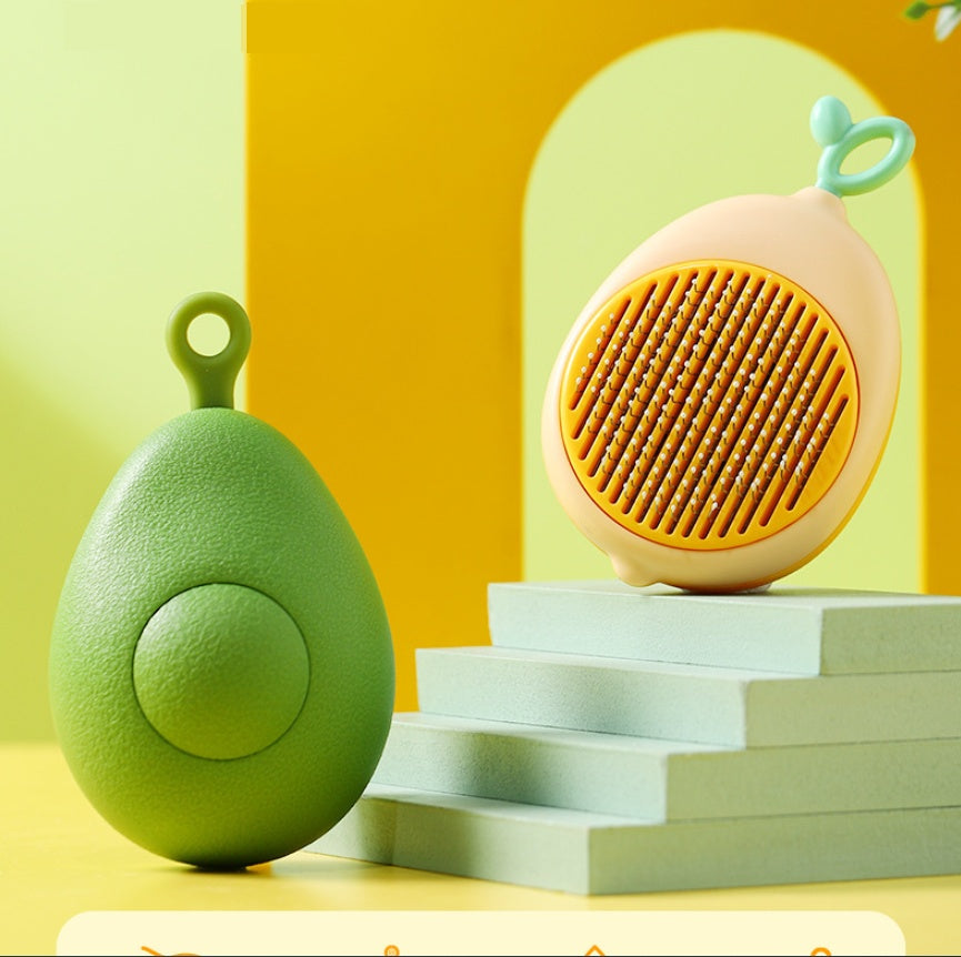 Two self-cleaning pet grooming brushes in avocado shape, one green and one yellow, displayed on white blocks
