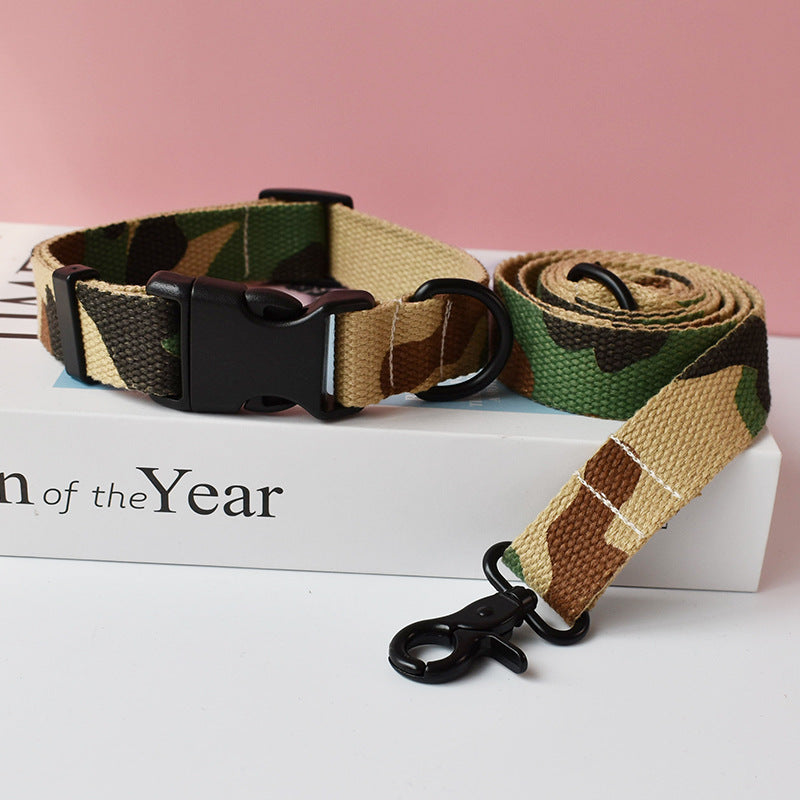 Camouflage patterned nylon dog collar with black plastic buckle and matching leash on white box