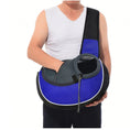 Load image into Gallery viewer, Man in white tank top holding blue breathable mesh pet sling carrier with small dog inside

