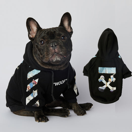 French bulldog wearing black artistic printed dog hoodie sitting next to matching displayed hoodie showing back design