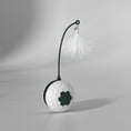 Load image into Gallery viewer, Close-up of white and green automatic rolling cat toy with feather teaser on a plain white background
