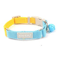 Load image into Gallery viewer, Close-up front view of blue and yellow woven dog collar with release buckle and blue bell
