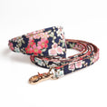 Load image into Gallery viewer, Navy floral dog collar with matching leash and gold-tone clasp laid flat
