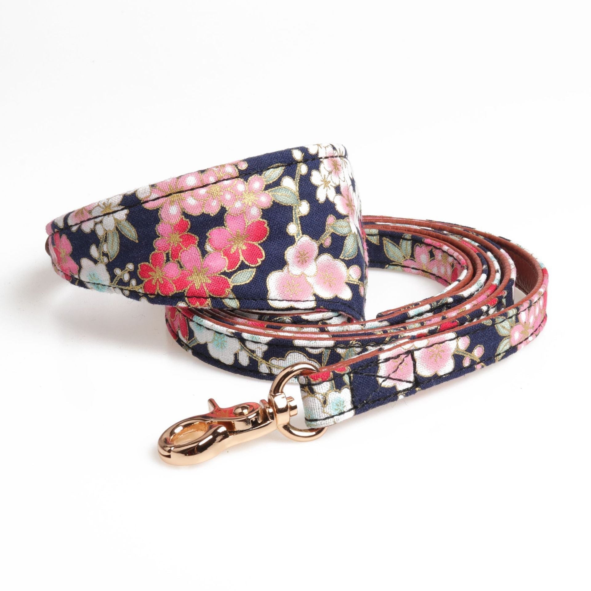 Navy floral dog collar with matching leash and gold-tone clasp laid flat