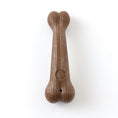 Load image into Gallery viewer, Close-up of bone-shaped brown dog chew toy showcasing texture and paw print design
