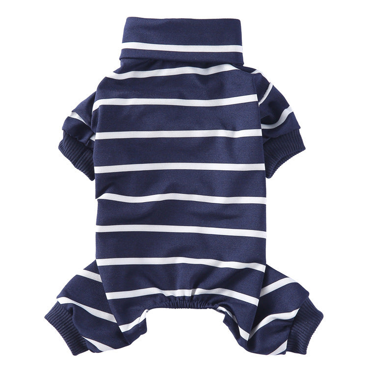 Small gray poodle wearing red and navy blue striped high collar pajamas sitting and panting