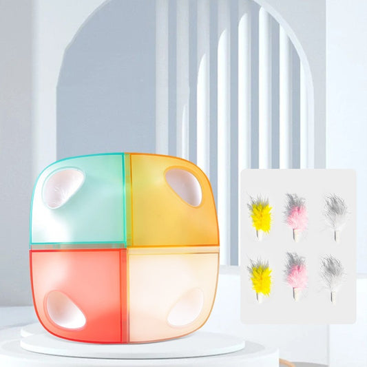 Colorful cube-shaped cat toy with four feather-filled compartments, displayed on white pedestal
