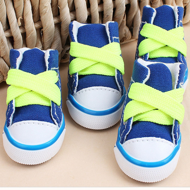 Blue mini canvas dog sneakers with bright yellow-green laces and classic rubber soles