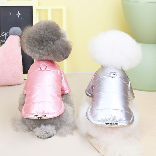 Two small fluffy dogs seen from the back wearing pink and silver waterproof padded dog jackets with metal leash rings