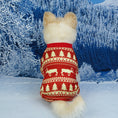 Charger l'image dans la visionneuse de la galerie, Small dog from behind wearing a red holiday pajama with cream Christmas tree and reindeer patterns against a winter snowy forest background
