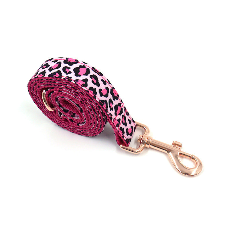 Rolled leopard print dog leash featuring pink and black spots with rose gold clasp