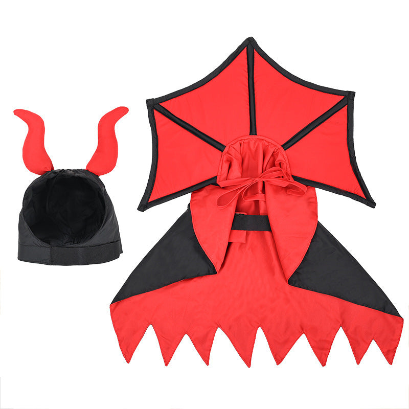 Flat lay of the black and red vampire cape and hood with plush red horns, showing the inner lining, Velcro fastenings, and costume shape