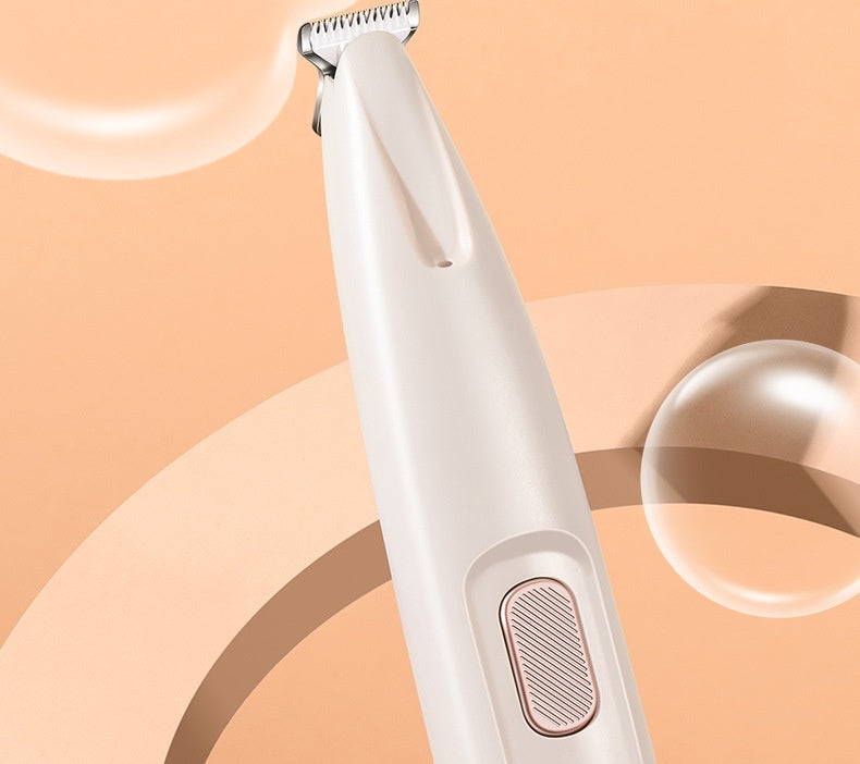Close-up view of white pet trimmer showing power button and blade design