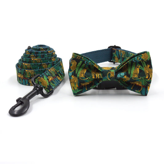Rolled green jungle print pet leash next to matching bowknot collar with black buckle