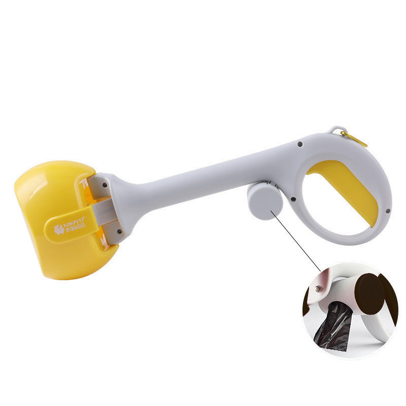 Close-up of yellow and gray dog waste scooper showing feature for dispensing waste bags