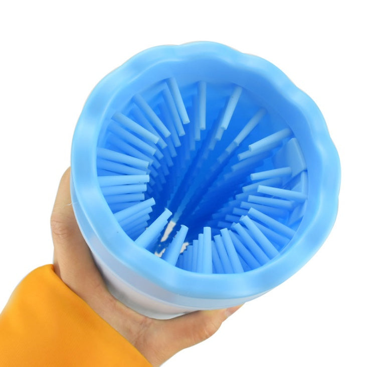Close-up of blue silicone paw washer bristles inside the cup held in hand