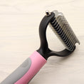 Load image into Gallery viewer, Close-up of dog grooming comb’s stainless steel double-sided blade with curved tips
