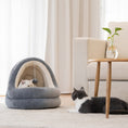 Load image into Gallery viewer, Gray plush pet cave bed placed on floor near sofa, with one cat inside bed and another cat nearby, highlighting the bed's cozy retreat design
