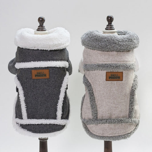 Back view of two plush wool blend dog coats on mannequins: one charcoal gray with white trim and one light gray with gray trim