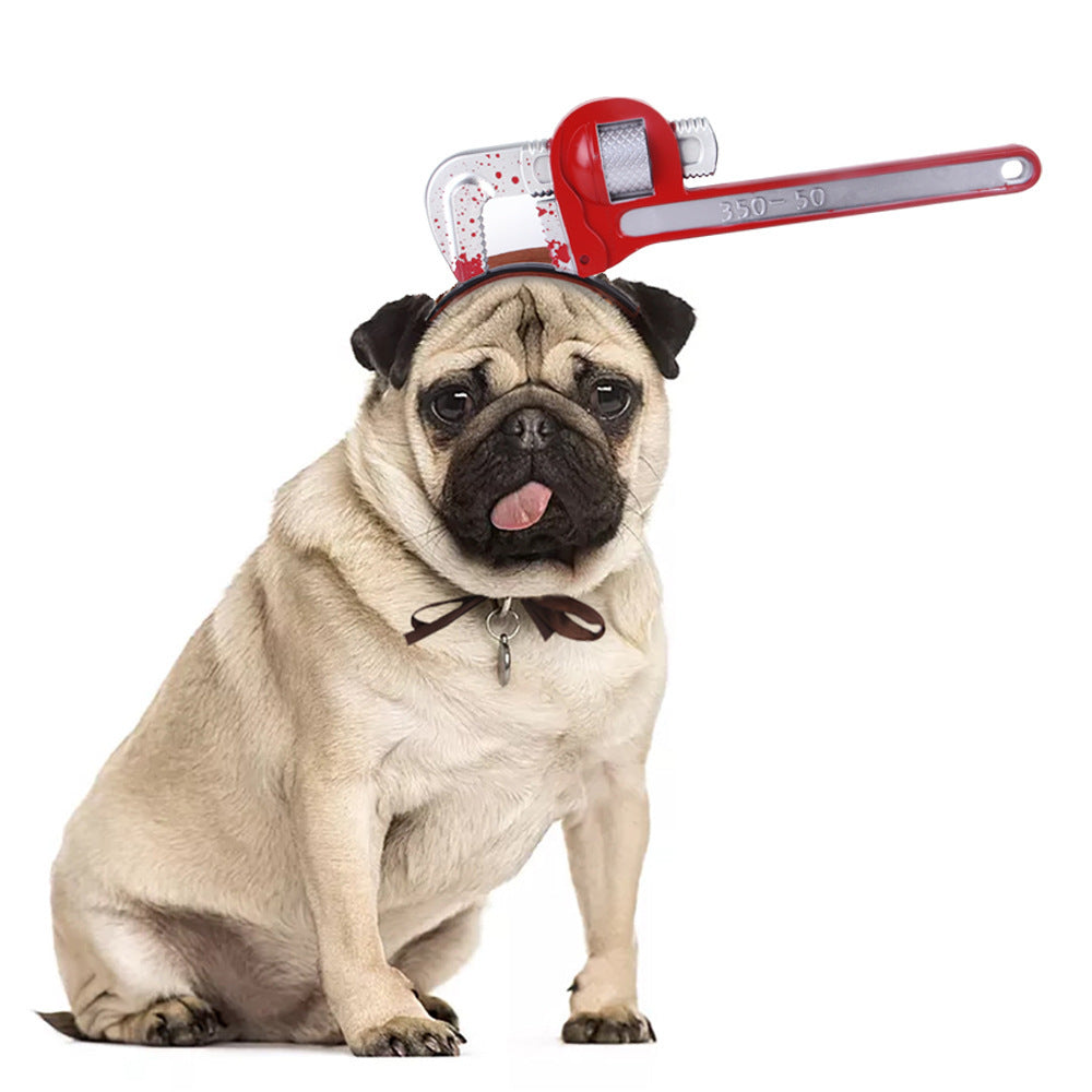 Black and white Boston terrier wearing bloody syringe accessory on headband
