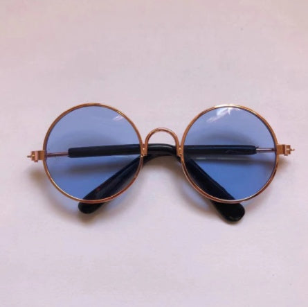 Rose gold round sunglasses for pets shown open with black ear arms visible  