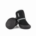 Load image into Gallery viewer, Close up view of black neoprene and rubber outdoor dog boots showing soles and branding
