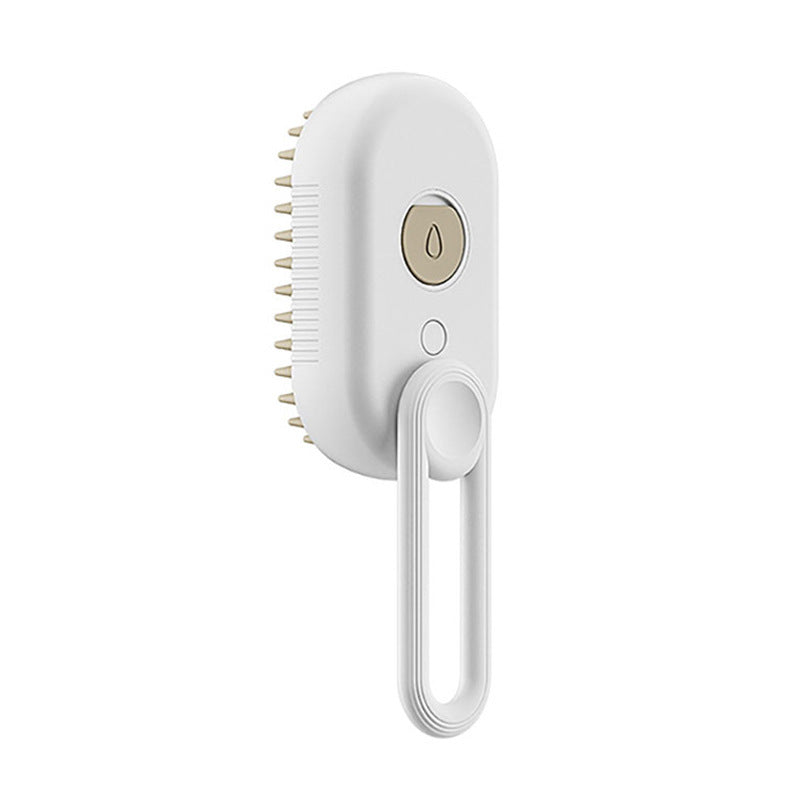 White pet brush with beige spray button and looped handle, side angle