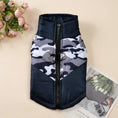 Cargar la imagen en la vista de la galería, Black and white camouflage padded dog jacket with zipper and leash attachment on a flat surface
