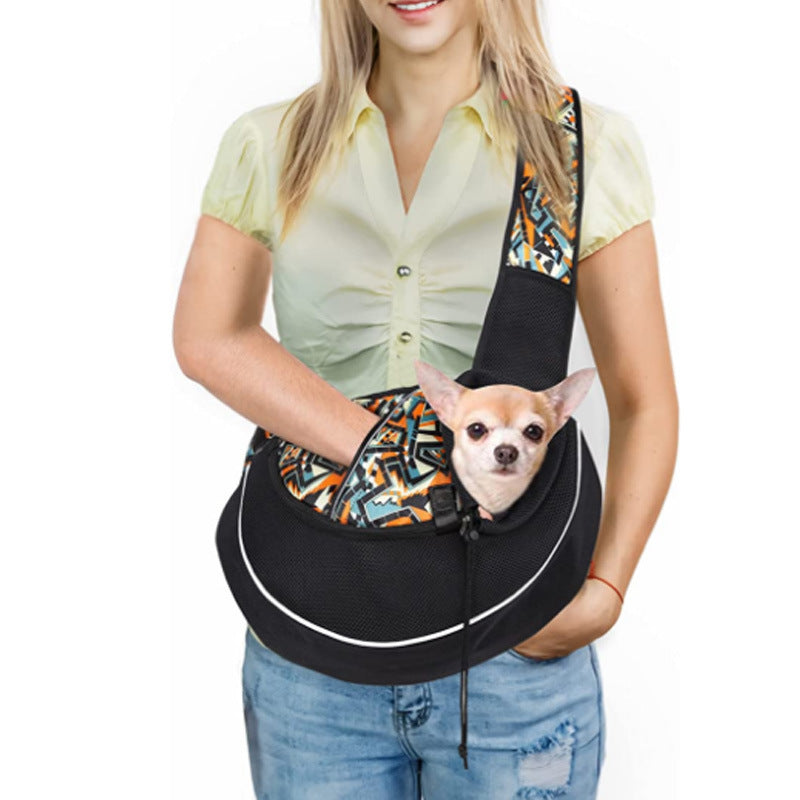 Woman carrying small chihuahua in patterned breathable pet sling carrier with orange and gray design