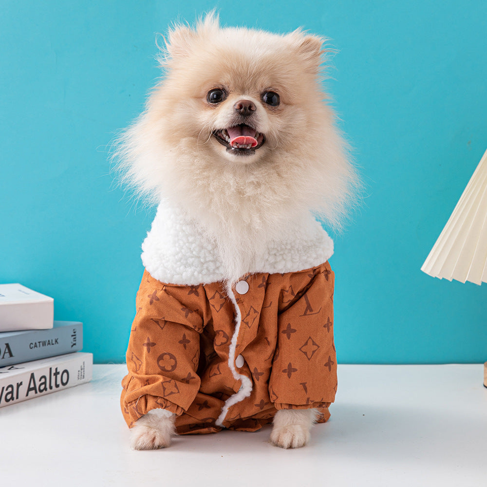 Front view of small fluffy dog smiling while wearing fleece-lined orange-brown dog jacket