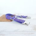 Load image into Gallery viewer, Side view of purple Halloween dog collar partially unbuckled, highlighting fabric pattern and metal hardware
