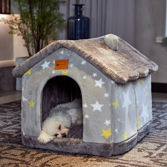 Grey star-patterned plush pet house with small dog sleeping inside on carpet