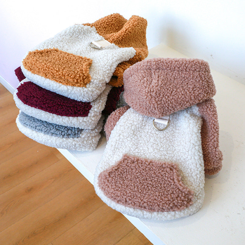 Stacked beige, burnt orange, deep red, and grey lamb fleece dog sweaters showing texture and design