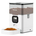Load image into Gallery viewer, Black automatic pet food feeder with dual stainless steel feeding bowls filled with dry pet food
