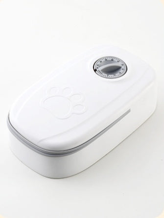 Single white automatic pet feeder with mechanical timer dial and paw-print embossed lid, shown on white background