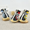 Load image into Gallery viewer, Close-up front angle of red, yellow, and blue breathable dog boots with zippered fronts and velcro straps
