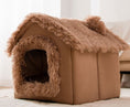 Cargar la imagen en la vista de la galería, Brown plush pet house with fluffy roof and rounded entrance on floor
